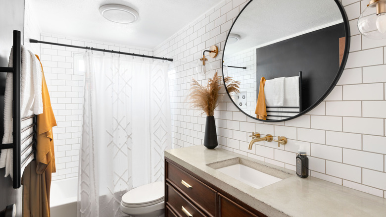 A bathroom with subway tile throughout on all the walls