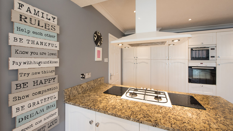 A word art plaque on a kitchen wall