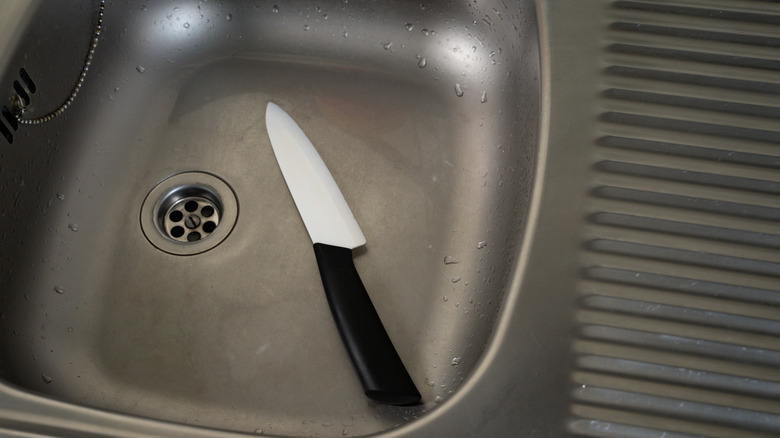 Close up of sharp kitchen knife in sink