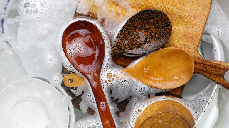 Close up of wooden tools soaking in soap and water
