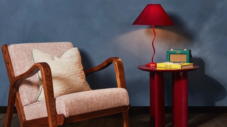 Dark blue limewash living room with red accents