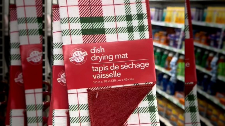 Red and green plaid dish drying mat hanging on a rack at Dollar Tree