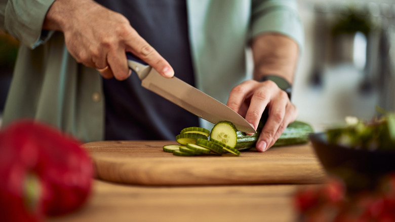 A man using a wooden cutting board