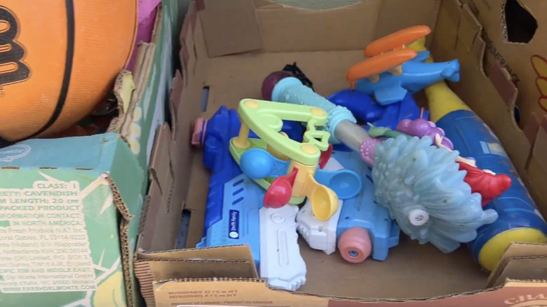 Repurposed Costco cardboard boxes used as storage bins for kids' toys.