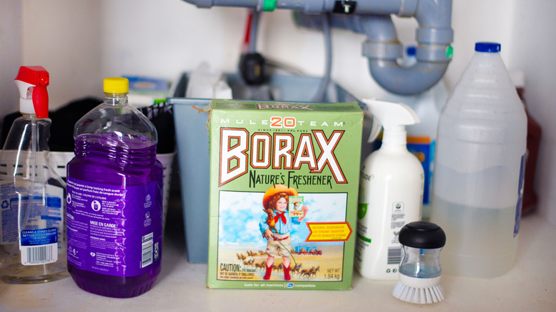 A box of Borax under the sink with other cleaning supplies