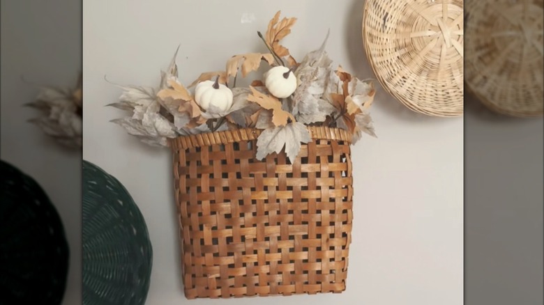 woven hanging basket filled with fall foliage