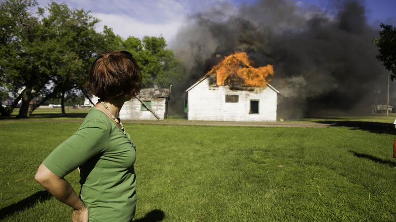 Woman watching a house fire