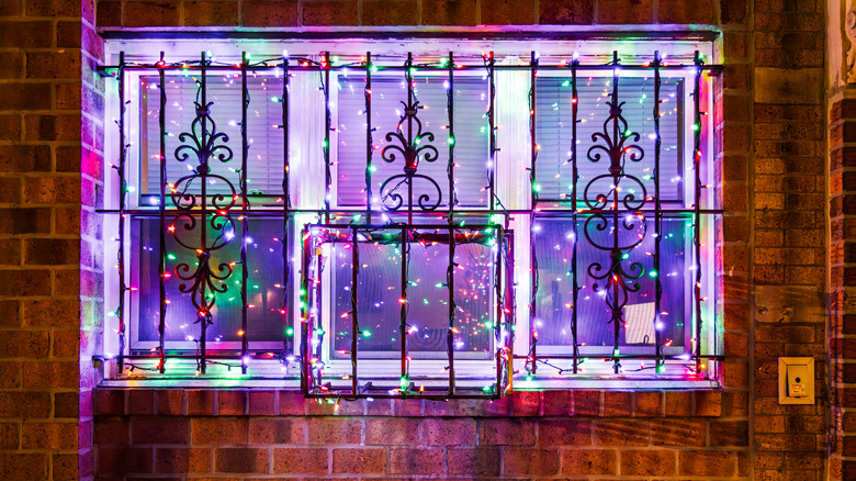 Window decorated with Christmas lights with security bars
