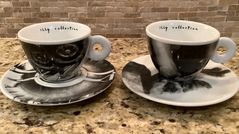 Black and white Illy Art Collection mugs on saucers on granite