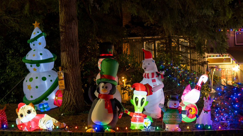 A front yard with inflatable Christmas décor.