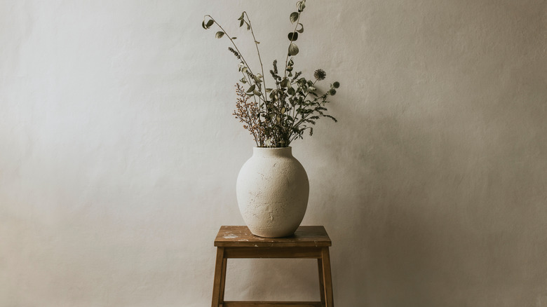 Greige wall with a greige planter on a stool