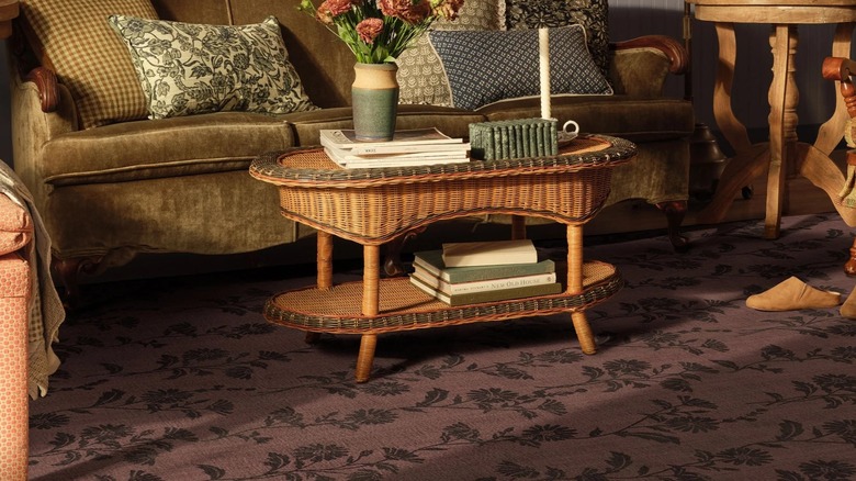 A dark brown floral rug in a living room