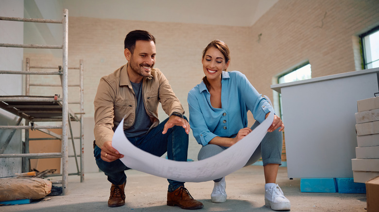 Couple looks at plans for their remodel.