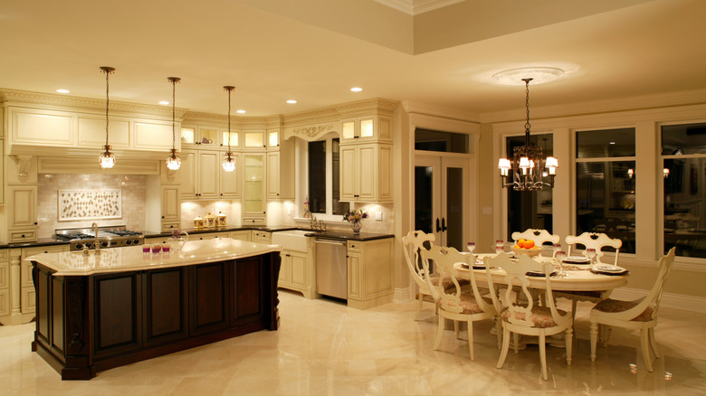 Kitchen with pendant lights over island and table