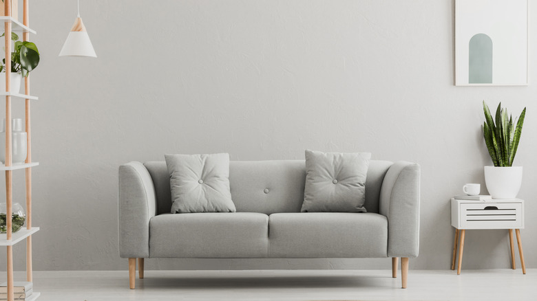 gray couch in front of gray wall