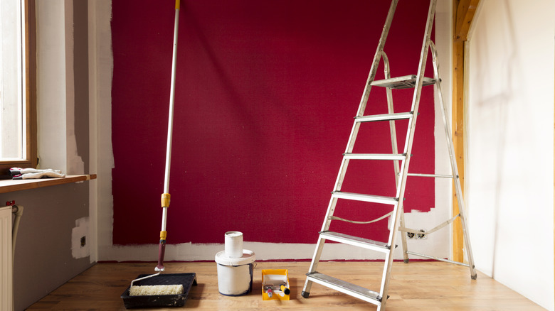 A wall in the process of being painted red