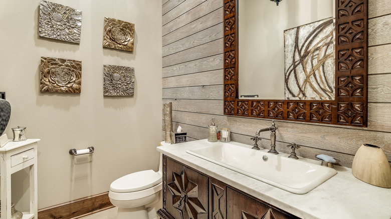 A grey shiplap accent wall in bathroom