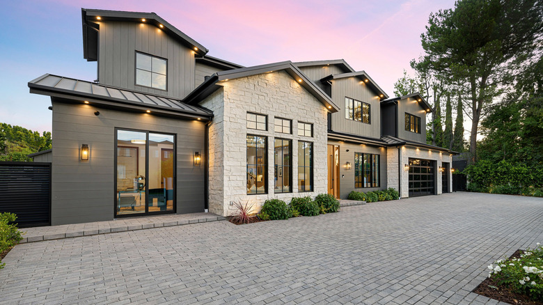 A large modern house with an interlocking pavers driveway.