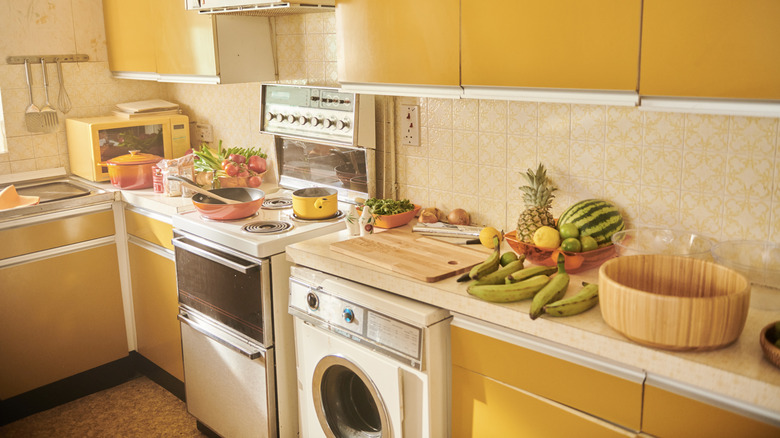 Retro 1970s kitchen with yellow cabinets