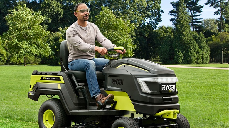 A man on a Ryobi riding lawn tractor