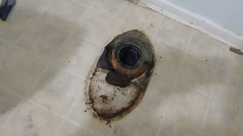 a damaged floor is exposed after a toilet is removed