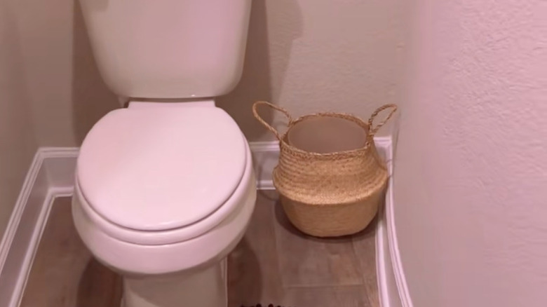 trash can inside woven basket