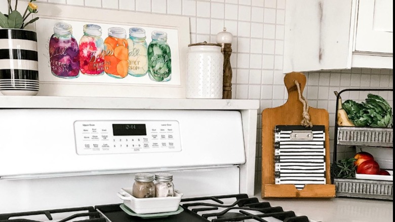 Shelf over the stove with art and decor