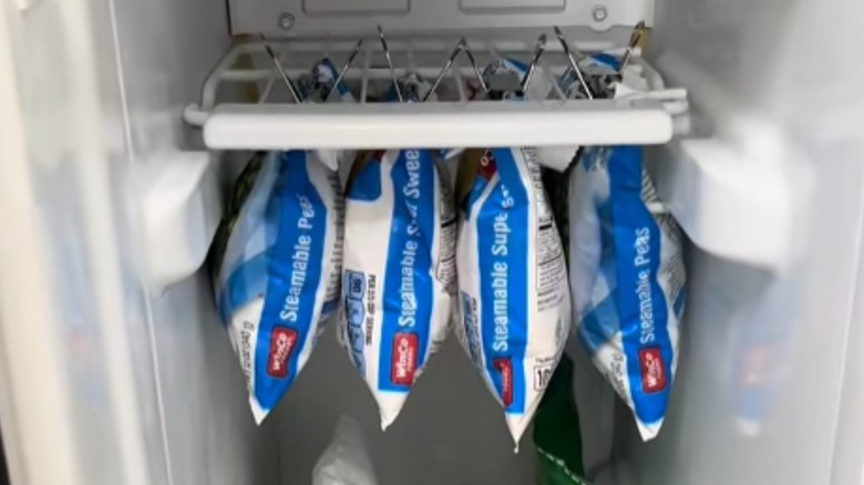 Binder clips on vegetable bags in freezer
