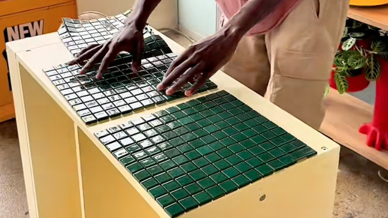 person tiling IKEA cabinet