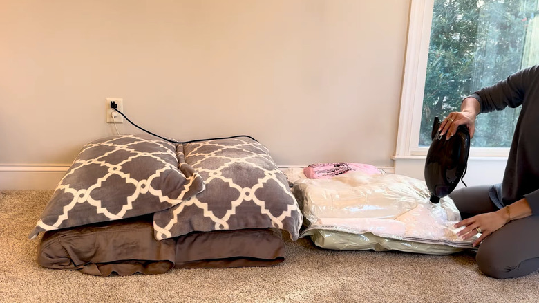 Woman stores blankets and pillows in vacuum bags