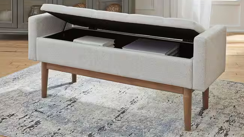 An upholstered storage bench with storage inside
