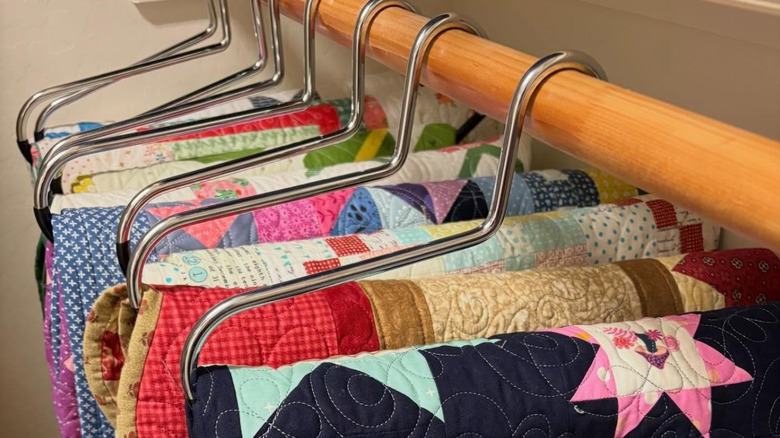 Blanket hangers being used to hang quilts