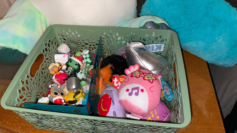 A basket with toys and small stuffed animals