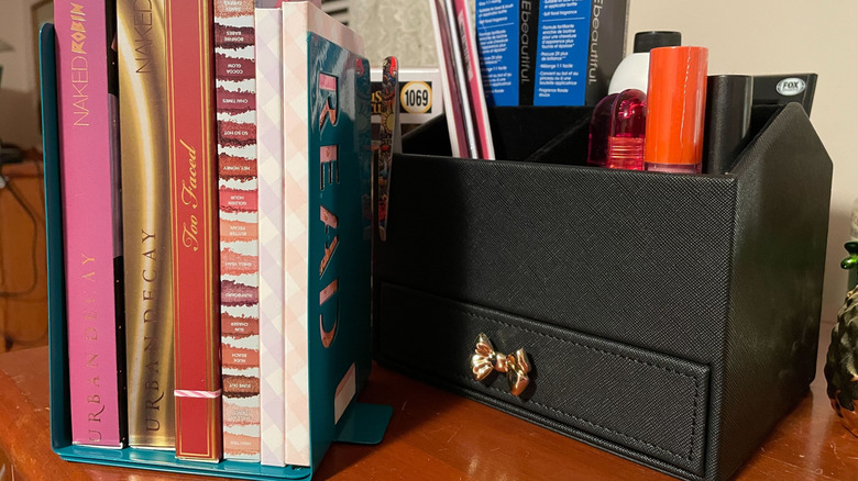 makeup palettes stored between two bookends