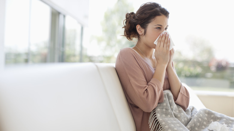 woman wiping nose
