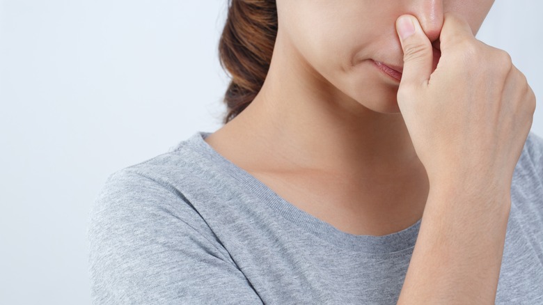 person holding nose