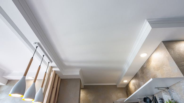 A white, modern kitchen ceiling taken at an upward angle