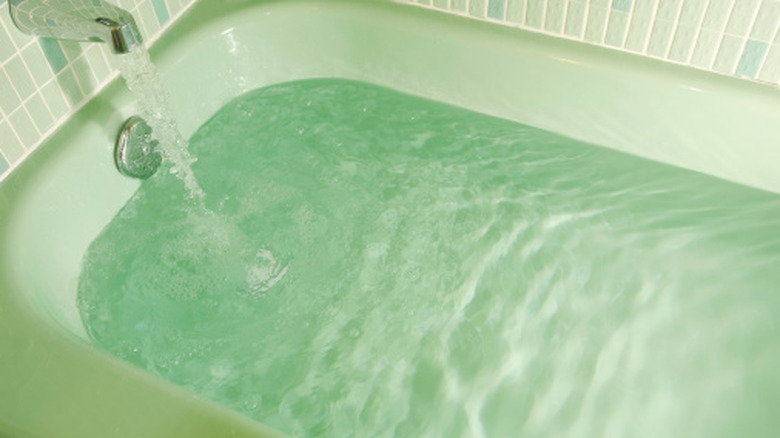 Green-colored bathtub and bathroom tiles