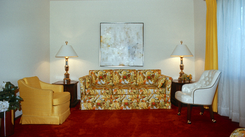 Living room with red shag carpet and floral upholstery