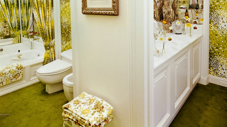 Bathroom with green carpeted flooring