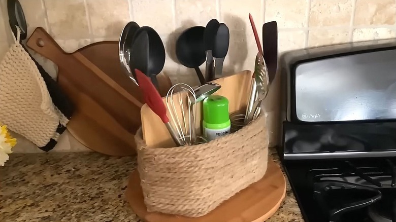 A lazy Susan with a DIY organizer on top holding kitchen utensils.