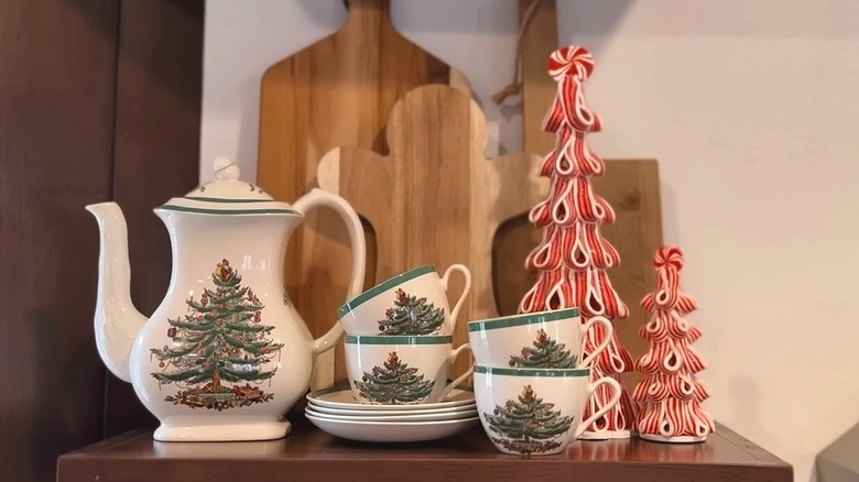 A Christmas-themed tea set on an open shelf.