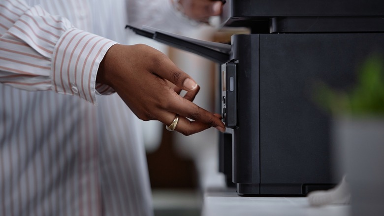 Hands of person using a personal printer