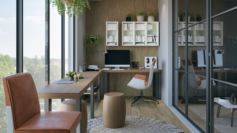 A modern home office with a wall of windows