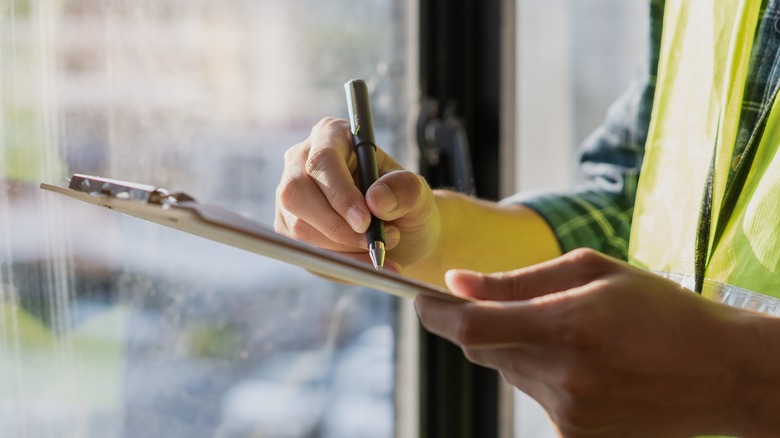 Home inspector making notes