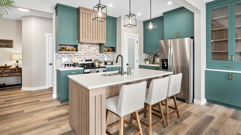 Clean modern kitchen with green cupboards