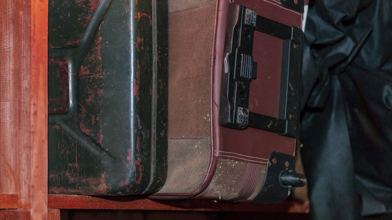 Old suitcases stacked on a shelf
