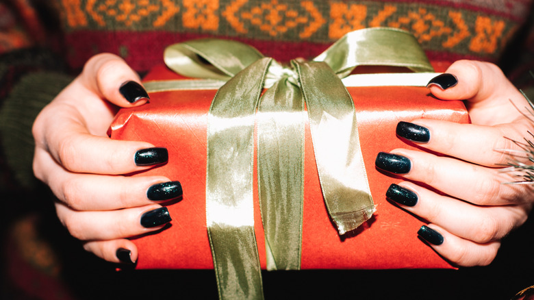 A person holding a wrapped gift