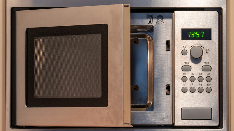 An empty microwave with the door open.