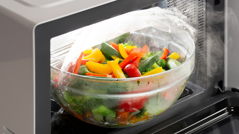 A vegetable medley, including peppers, heated up in the microwave.